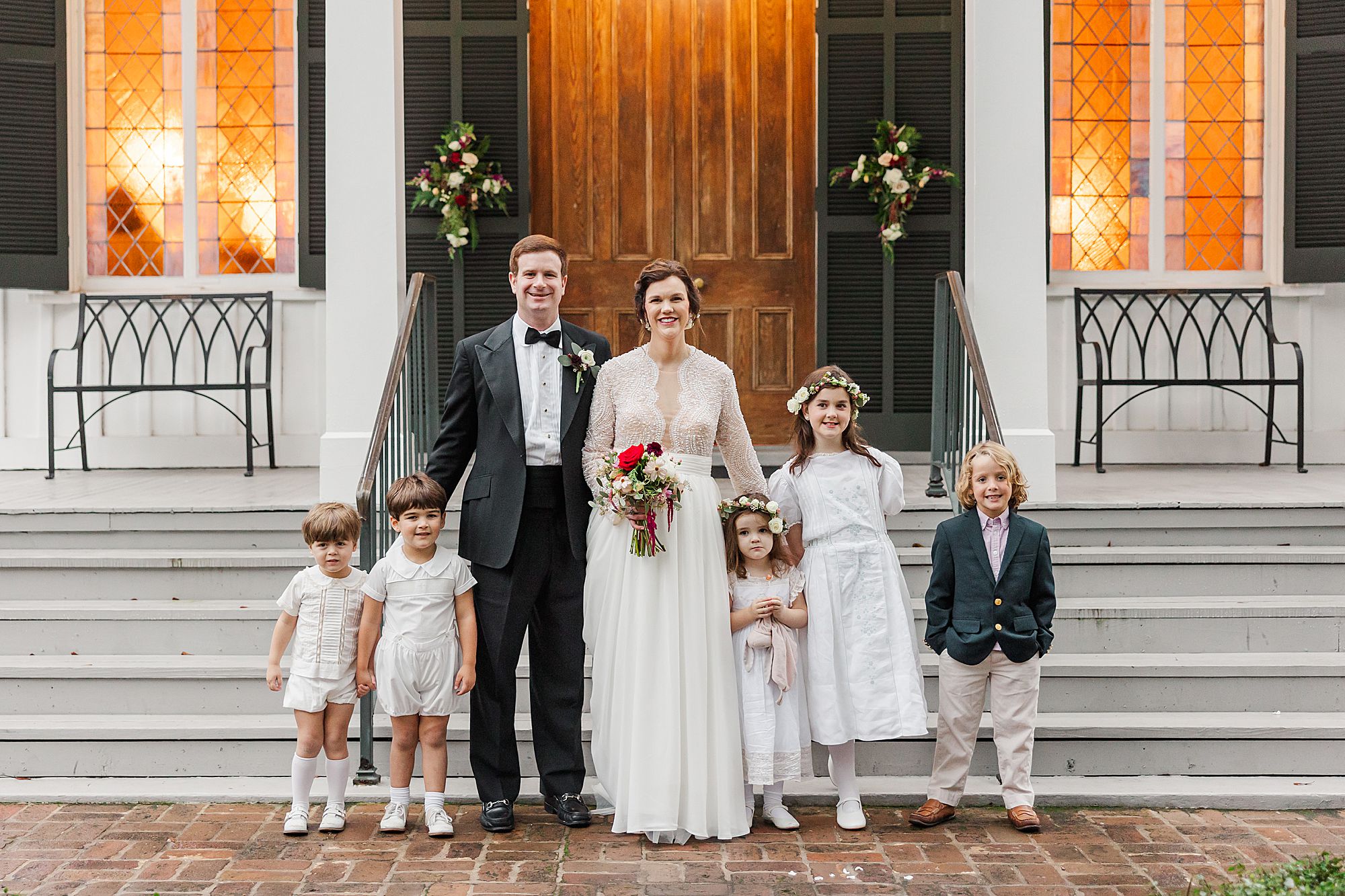 Bride and groom with lots of flower girls and ring bearers